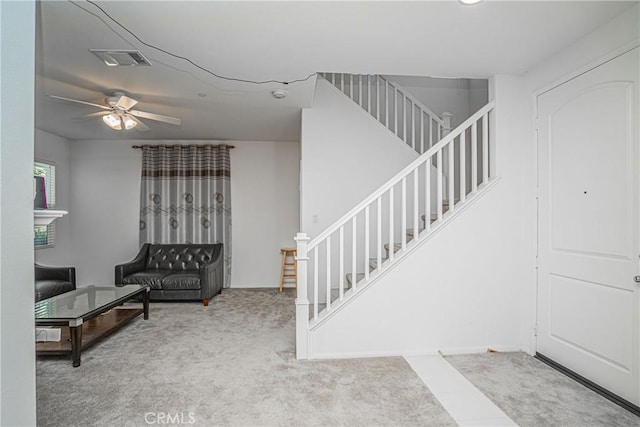 living room featuring light carpet and ceiling fan