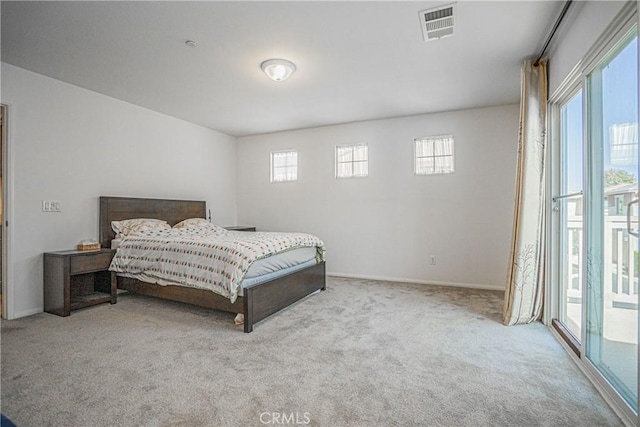 bedroom featuring access to exterior and light colored carpet