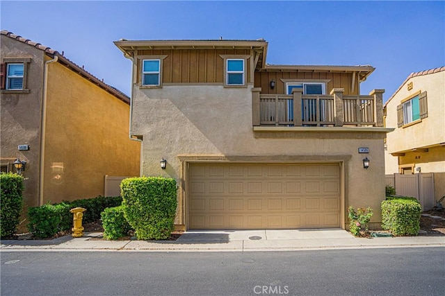 townhome / multi-family property with a balcony and a garage