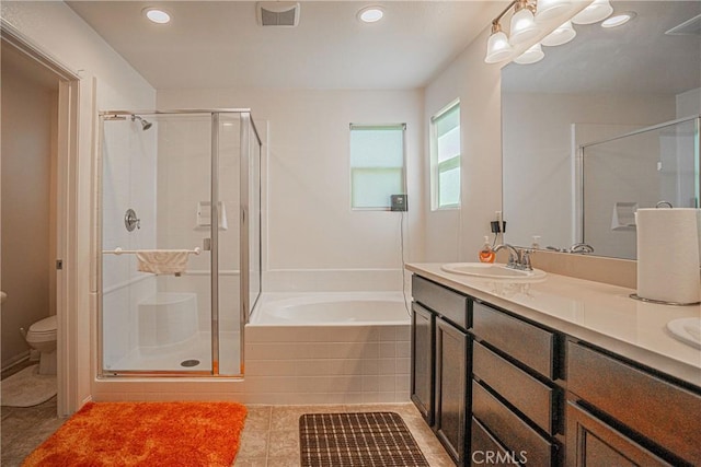 full bathroom featuring tile patterned floors, vanity, plus walk in shower, and toilet