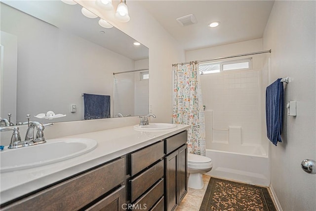 full bathroom with tile patterned floors, vanity, toilet, and shower / bath combo with shower curtain