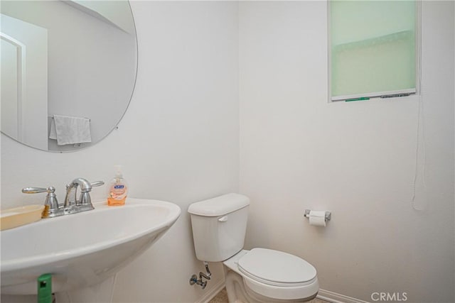 bathroom featuring toilet and sink