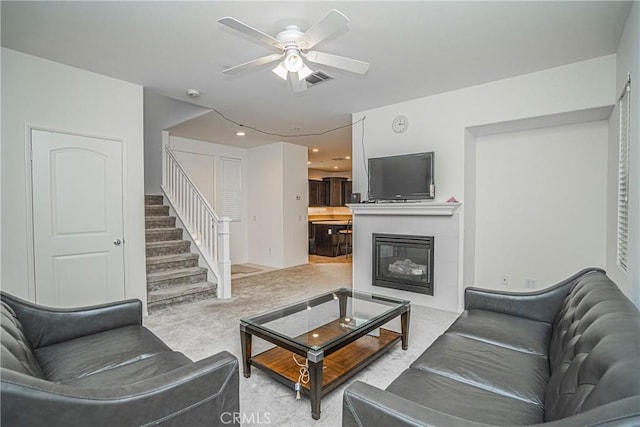 living room with ceiling fan and light colored carpet