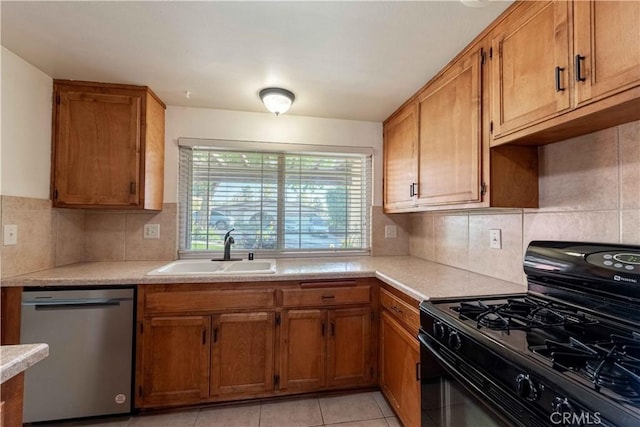 kitchen featuring sink, stainless steel dishwasher, light tile patterned floors, tasteful backsplash, and black range with gas cooktop