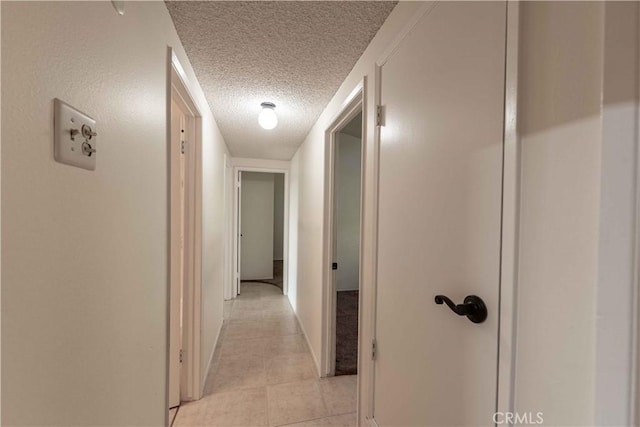 hallway with a textured ceiling