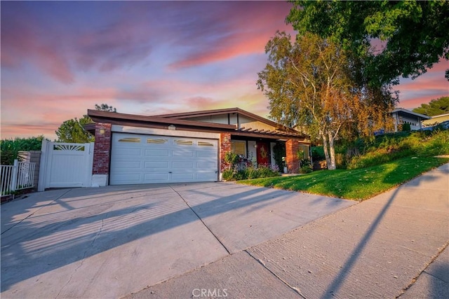 view of front of home with a yard and a garage