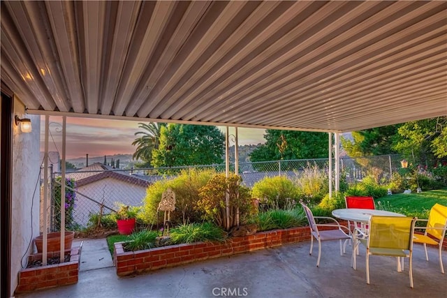 view of patio terrace at dusk