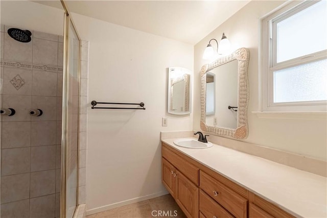 bathroom with tile patterned floors, vanity, and walk in shower