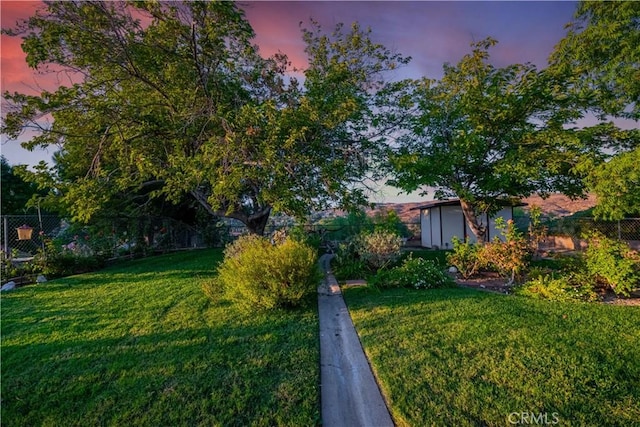 view of yard at dusk