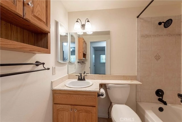 full bathroom with vanity, toilet, and tiled shower / bath