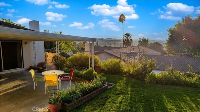 view of yard with a mountain view and a patio