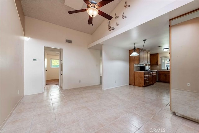 kitchen featuring pendant lighting, light tile patterned floors, high vaulted ceiling, and ceiling fan