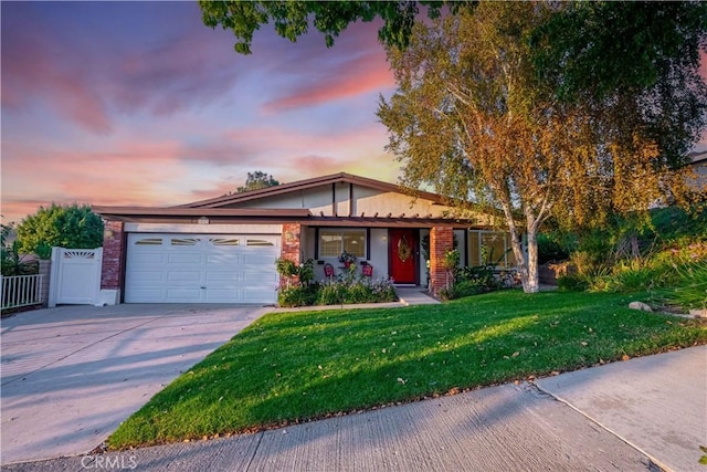 view of front of property with a yard and a garage