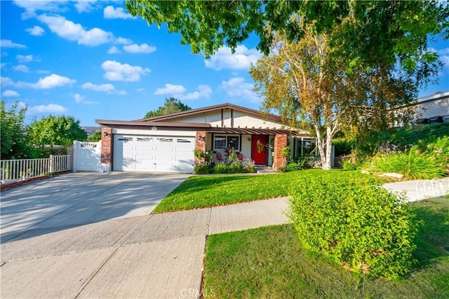 view of front of home with a garage and a front lawn