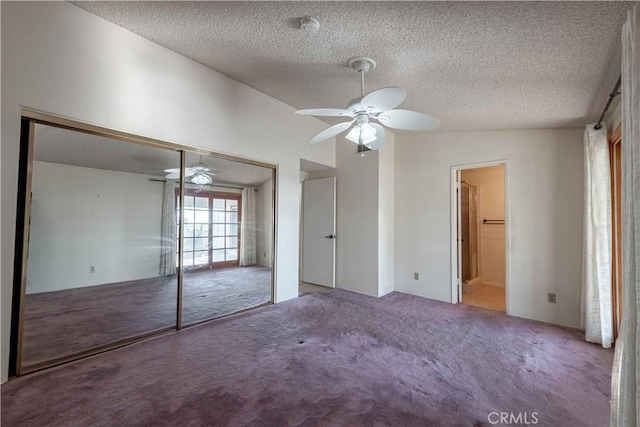 unfurnished bedroom featuring carpet flooring, ceiling fan, lofted ceiling, and a textured ceiling