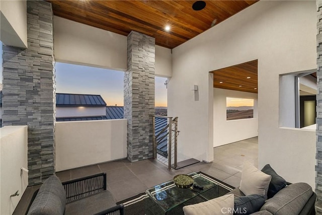 interior space with a balcony and an outdoor living space