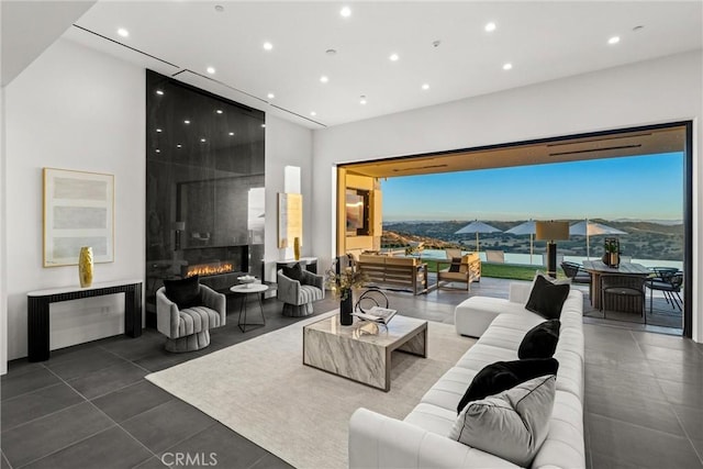 living room with tile patterned floors, a mountain view, and a fireplace