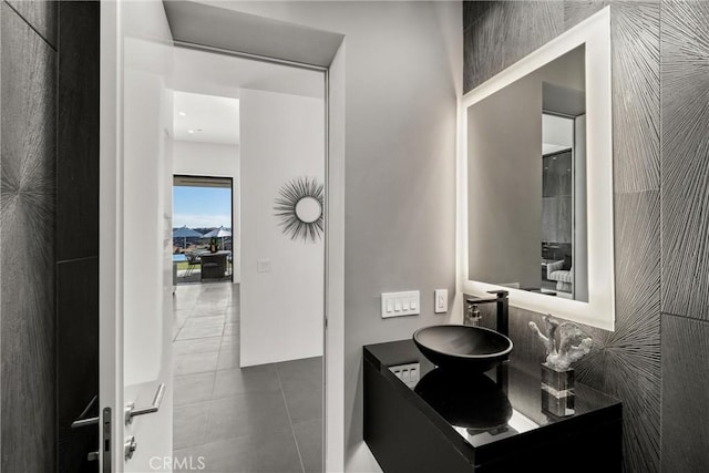 bathroom with vanity, tile patterned floors, and tile walls