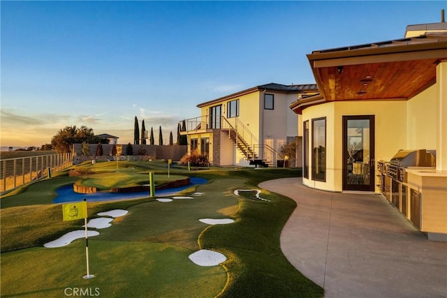 exterior space with area for grilling, a patio, fence, and stairs