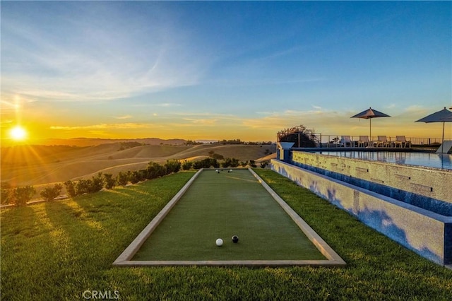 view of property's community featuring a lawn and a water view