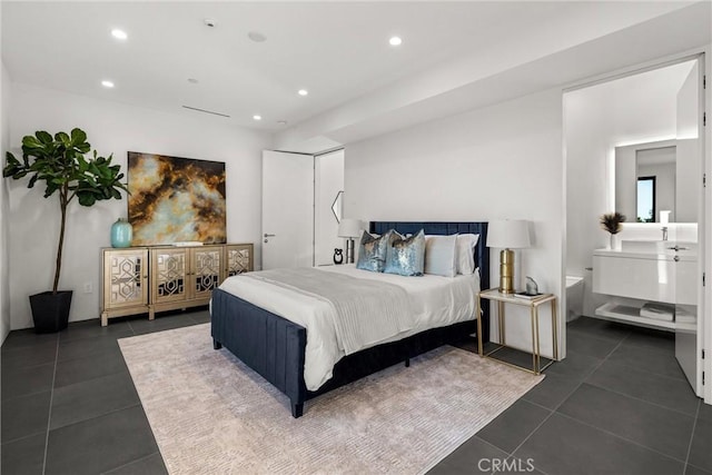 bedroom with dark tile patterned floors and recessed lighting
