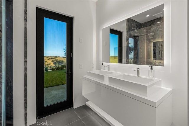 bathroom featuring tile patterned flooring, vanity, and an enclosed shower