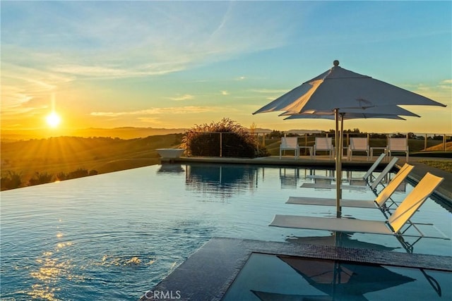 pool at dusk with a boat dock