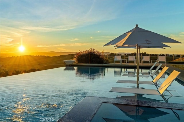 view of pool at dusk