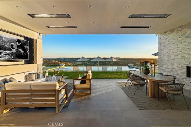balcony with outdoor lounge area, a patio area, and outdoor dining space