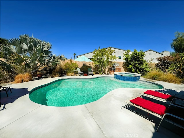 view of swimming pool featuring an in ground hot tub and a patio area