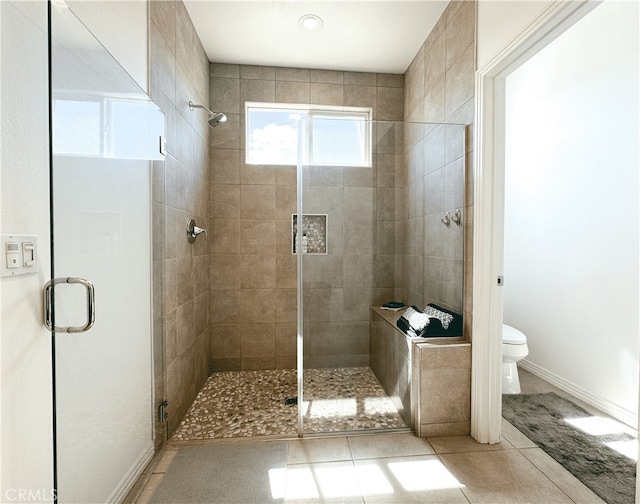 bathroom with toilet, tile patterned flooring, and an enclosed shower