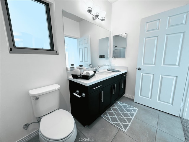 bathroom with vanity, toilet, and tile patterned floors