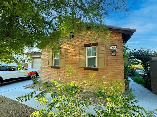 view of side of home featuring a garage