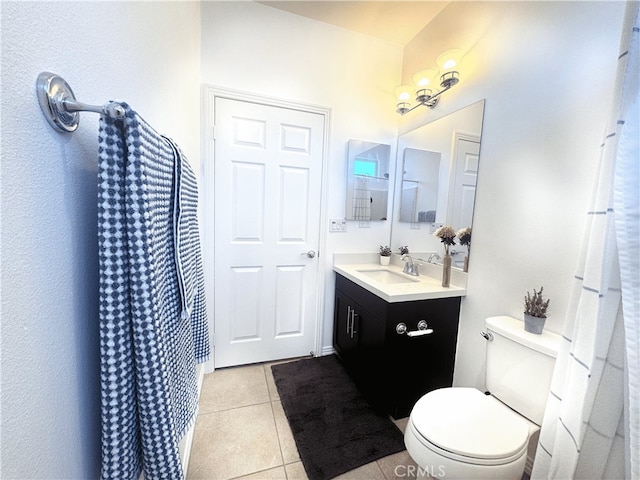 bathroom with vanity, toilet, and tile patterned flooring