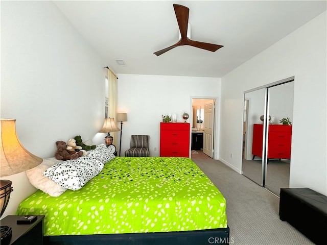 bedroom featuring a closet, ceiling fan, connected bathroom, and carpet floors