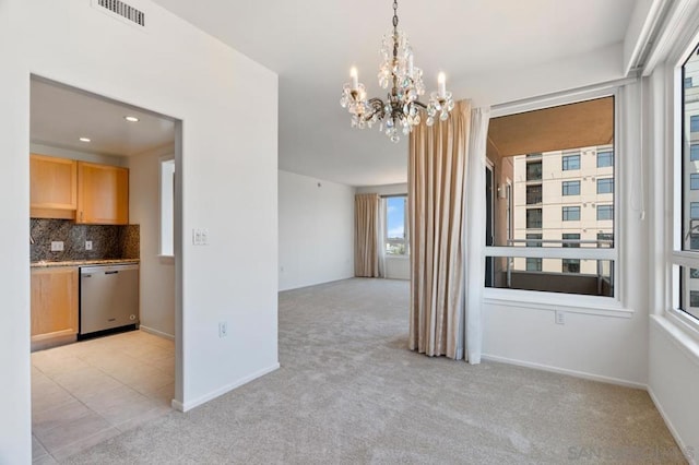 interior space with light carpet and a chandelier