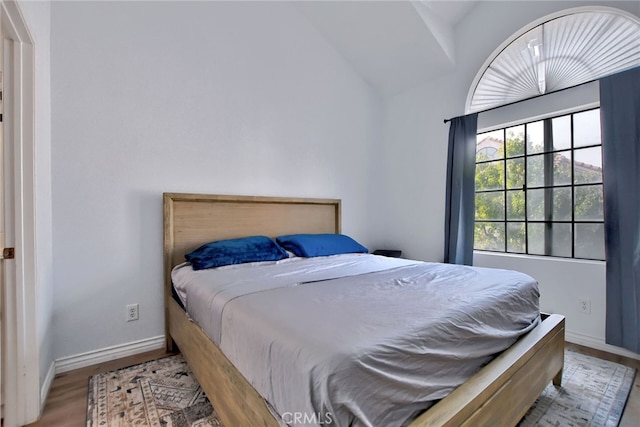 bedroom featuring vaulted ceiling and light hardwood / wood-style flooring