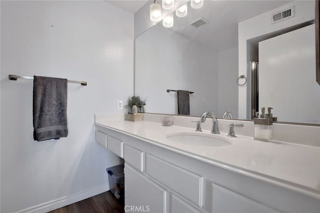 bathroom with vanity and wood-type flooring