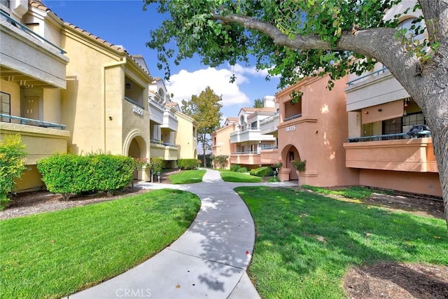 view of home's community featuring a lawn and a residential view