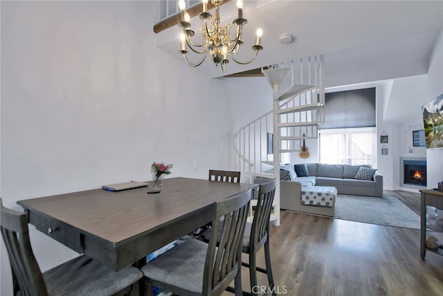 dining space with a towering ceiling and dark hardwood / wood-style floors