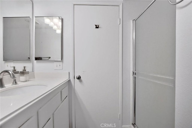 full bathroom with vanity and a shower with shower door
