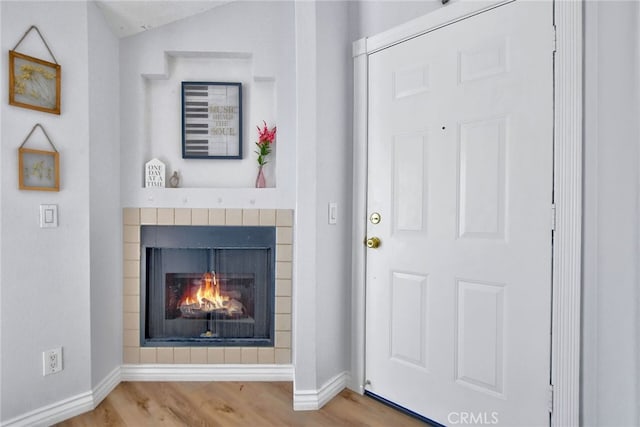 entrance foyer with hardwood / wood-style flooring and vaulted ceiling