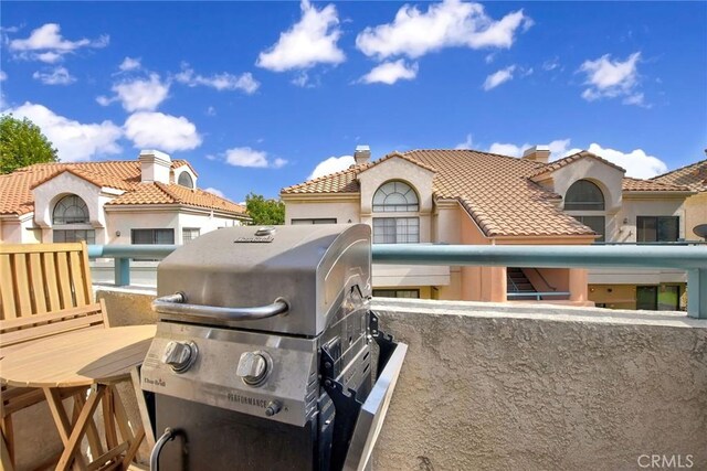 exterior space featuring a tiled roof and a chimney