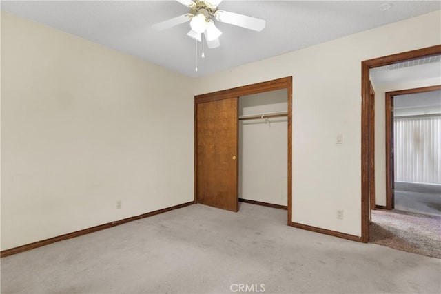 unfurnished bedroom with ceiling fan, light colored carpet, and a closet