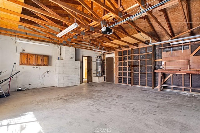 garage featuring water heater and a garage door opener