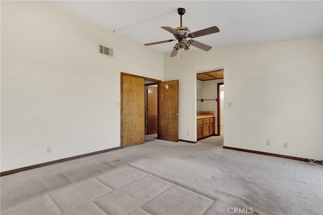 carpeted empty room featuring ceiling fan and lofted ceiling