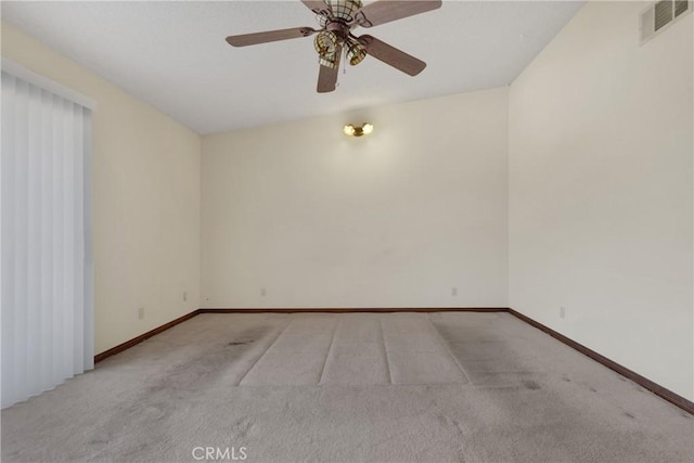 empty room featuring ceiling fan, light colored carpet, and lofted ceiling