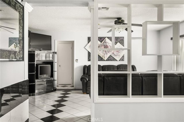 interior space with tile patterned floors and a textured ceiling