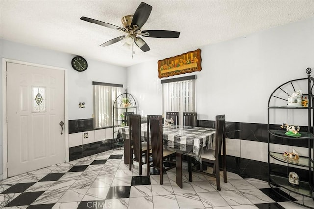 dining space featuring a textured ceiling and ceiling fan