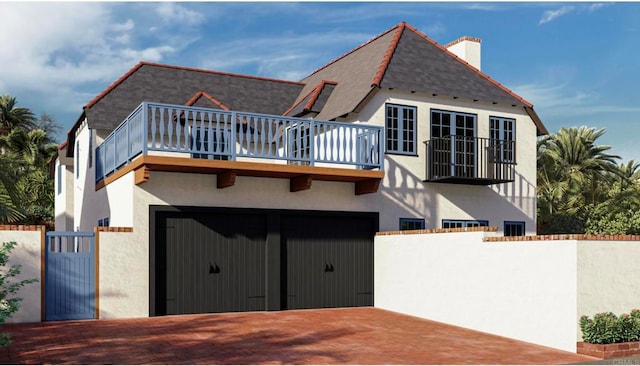 rear view of property with a balcony